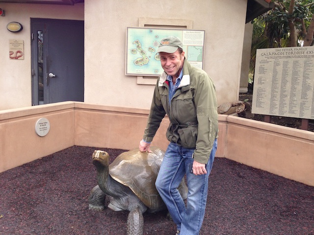 Uncle Jimmy posing with a turtle statue.