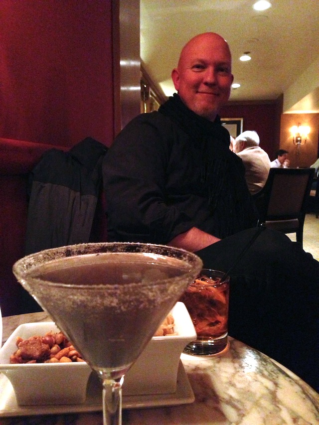 David in the lounge, with my lavender martini in the foreground. fo